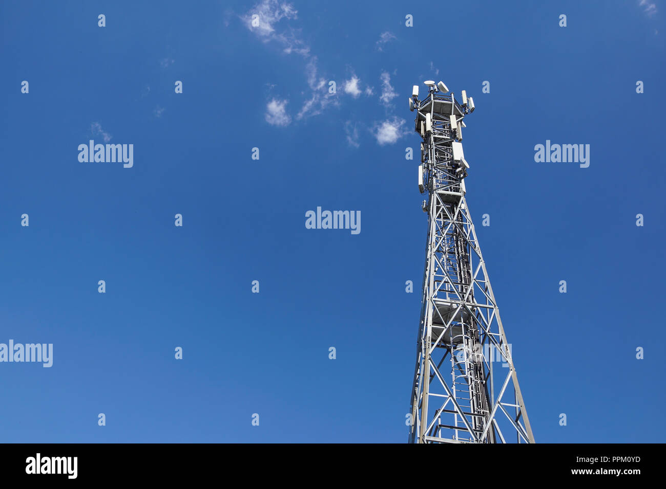 Telecommunication tower with antennas with blue sky . Stock Photo