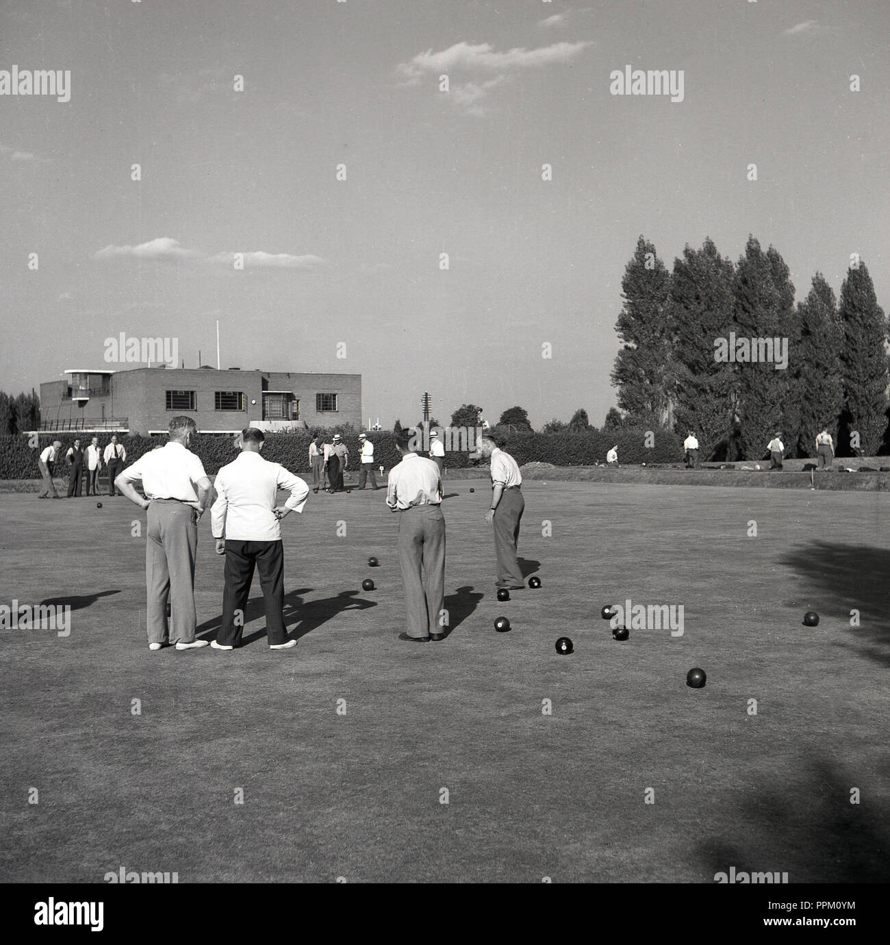 1950s, historical, outside at a sports club, on a bowling green, a number of senior men playing a game of lawn bowls, England UK. Stock Photo