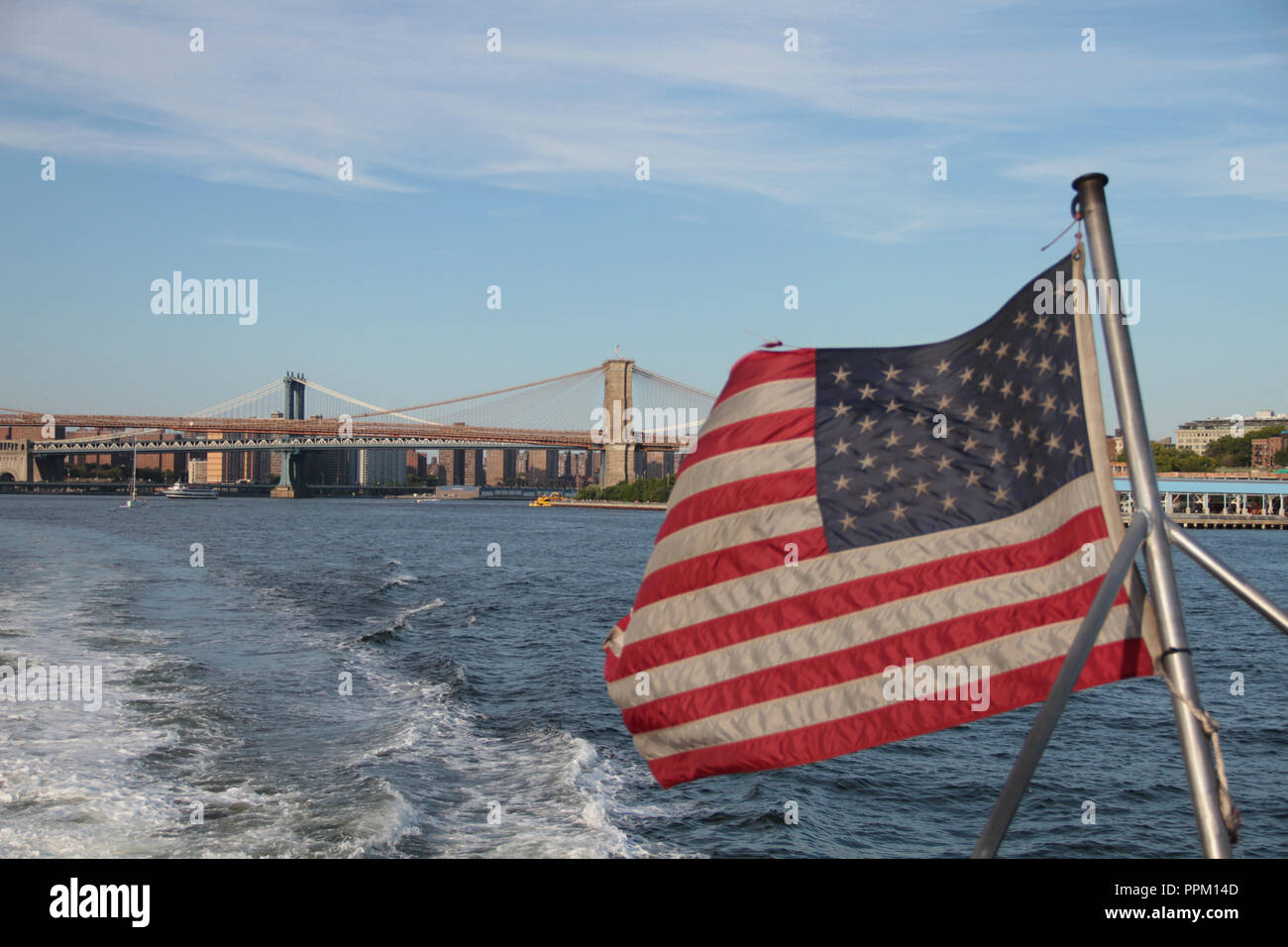 American Flag and Brooklyn Bridge Stock Photo