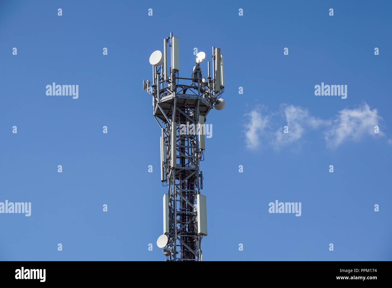 Telecommunication tower with antennas with blue sky . Stock Photo