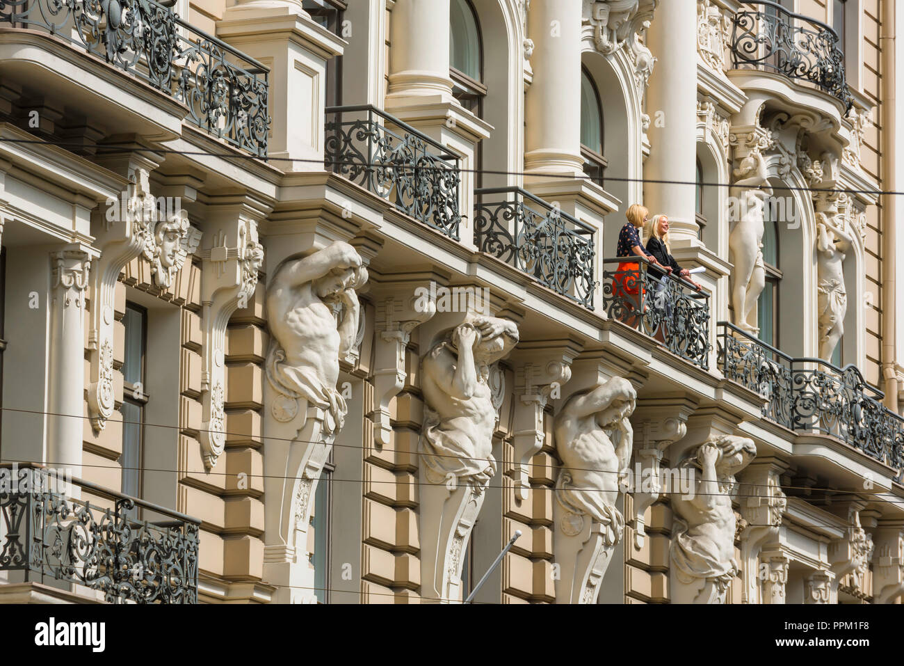 Riga art nouveau architecture, view of two women standing on the balcony of a building in Elizabetes Iela in the the Art Nouveau district of Riga. Stock Photo