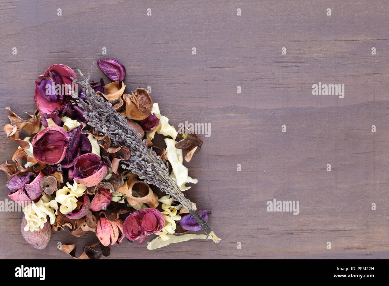 Potpourri mixture with lavender on a purple wood background with copy