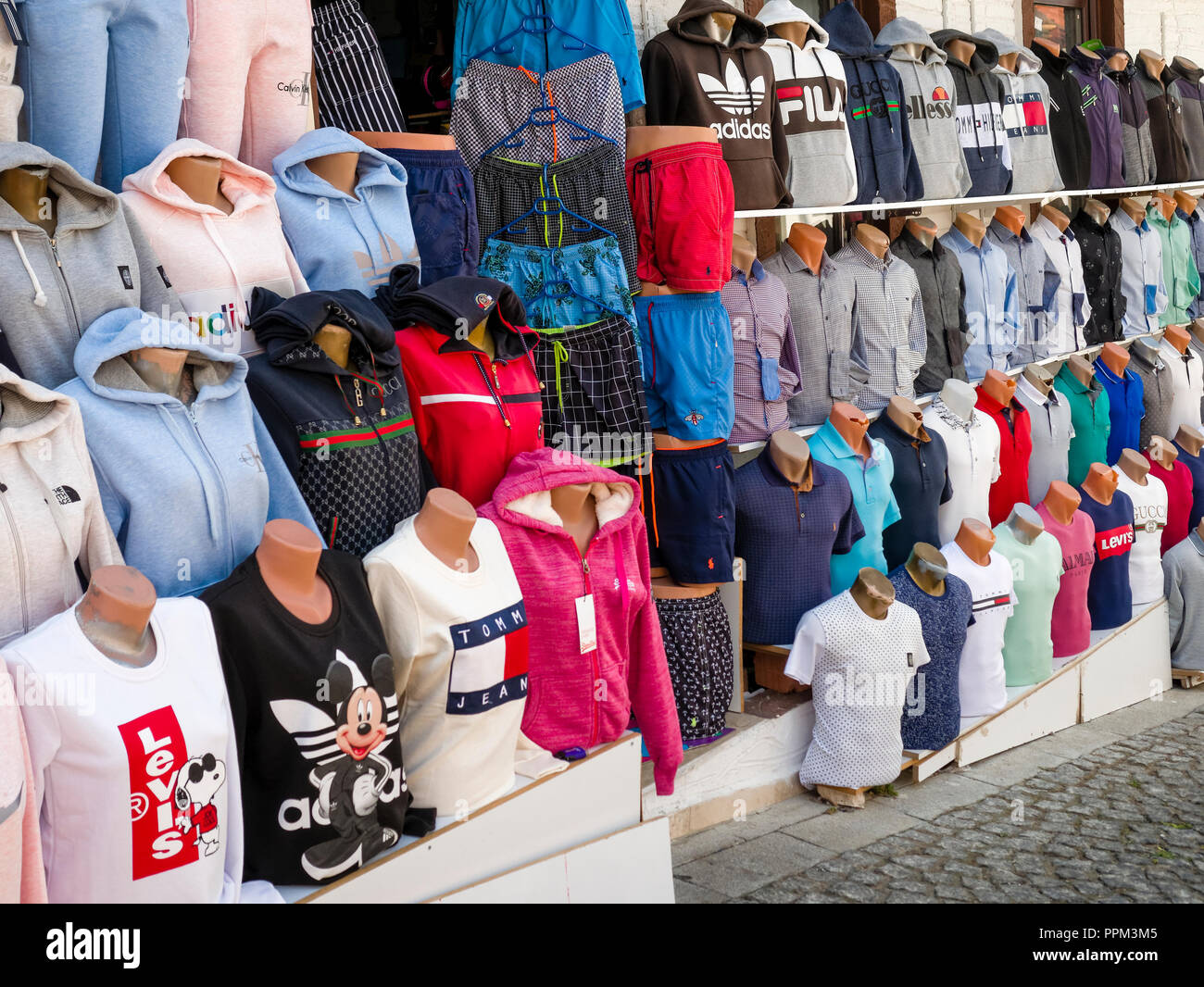 Counterfeit or fake designer clothing for sale outside shop in the busy  harbour area of Kalkan Stock Photo - Alamy