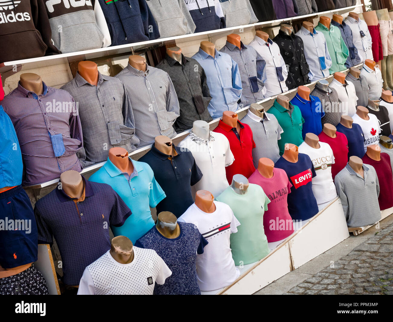 Counterfeit or fake designer clothing for sale outside shop in the busy harbour area of Kalkan Stock Photo