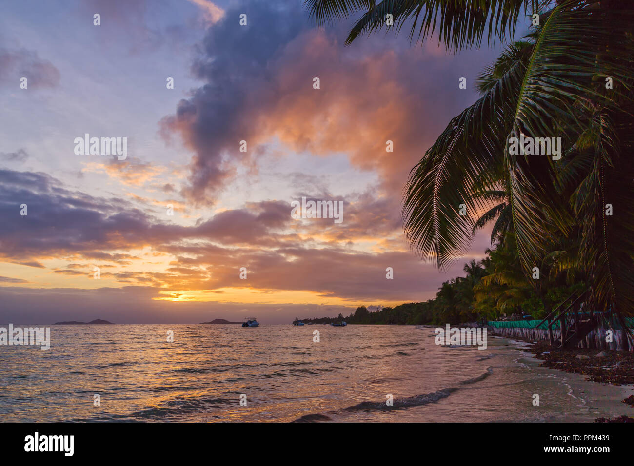 A colorful sunset at the Grand Anse on Praslin. Stock Photo