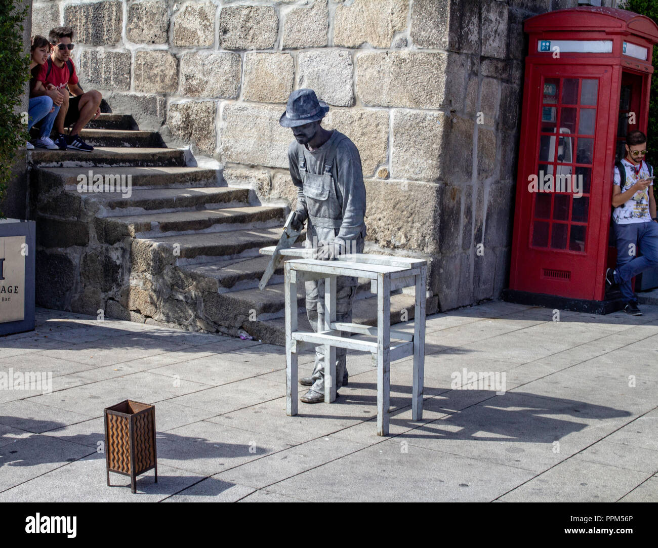 Porto, Portugal. One of the many street living statue artists who lend colour to the quayside of the Douro River in Porto, Portugal. Stock Photo