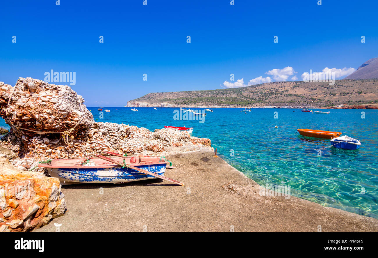 The gulf outside of the amazing caves of Dirou with fishing boats and turquoise waters, Peloponnese, Greece. Stock Photo