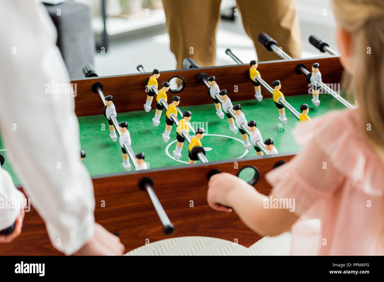 cropped shot of family playing table football together at home Stock Photo