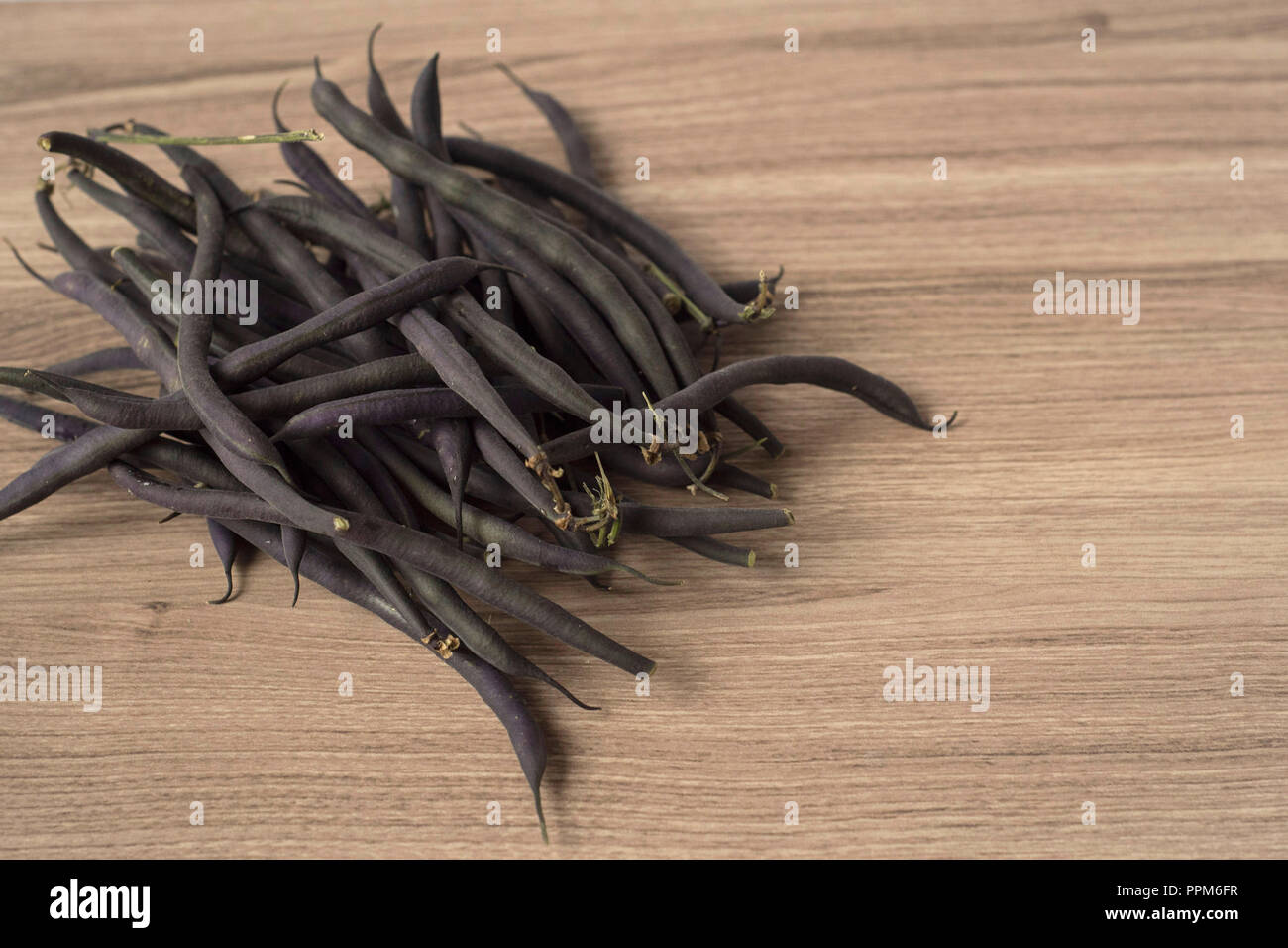 Farm Fresh Violet Green Beans Ready for Food Prep on a Wood Counter Stock Photo