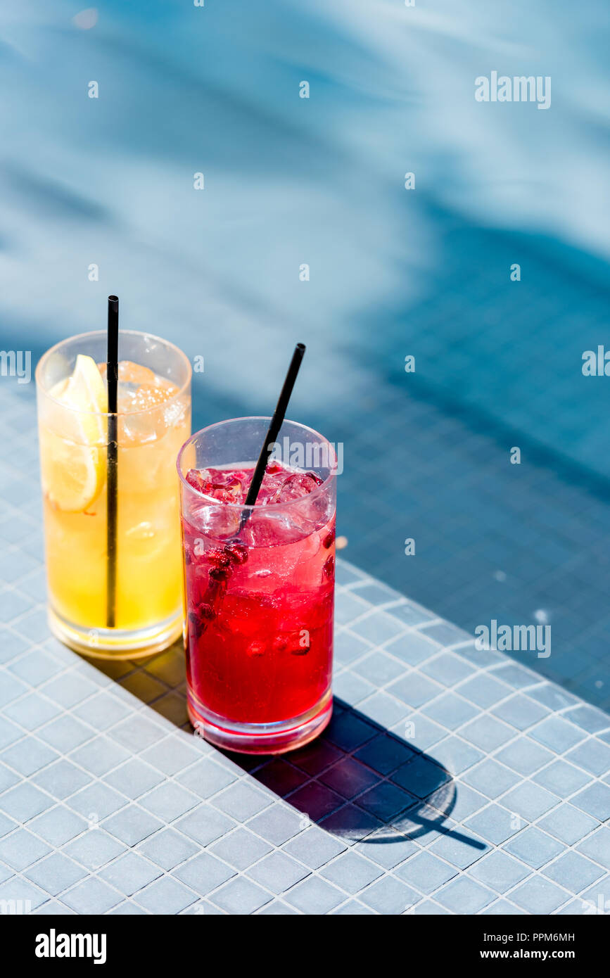 https://c8.alamy.com/comp/PPM6MH/close-up-shot-of-glasses-of-delicious-fruit-cocktails-on-poolside-PPM6MH.jpg