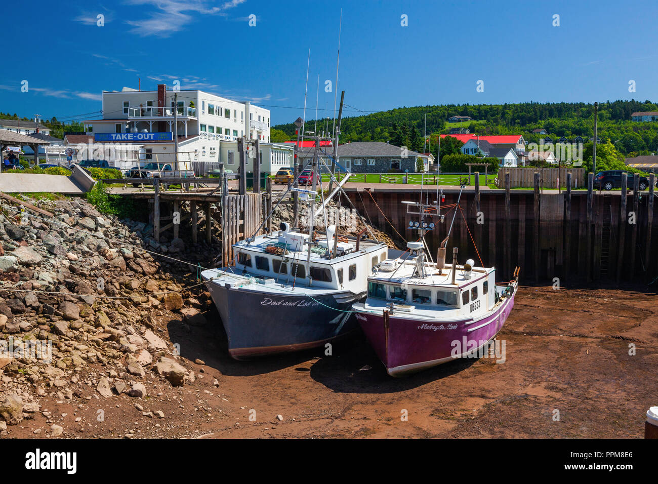 Fishing boats at low tide, Bay of Fundy, Alma, New Brunswick Stock