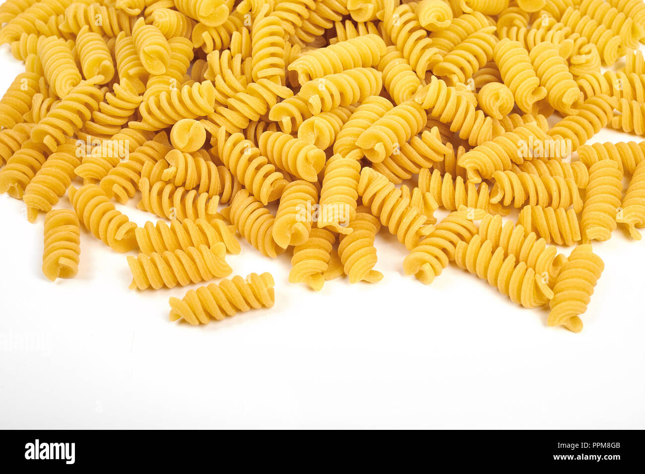 uncooked fusilli pasta noodles isolated on white background Stock Photo