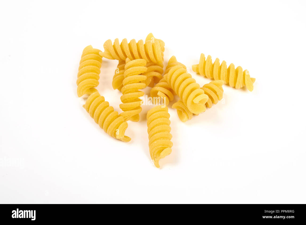 uncooked fusilli pasta noodles isolated on white background Stock Photo
