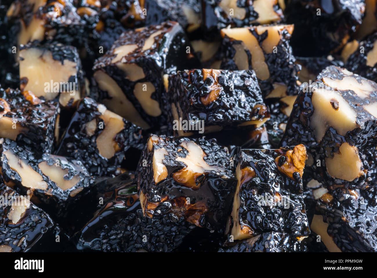 Ejiao Gao walnut and sesame donkey hide gelatin cubes close-up for use in chinese traditional medicine Stock Photo