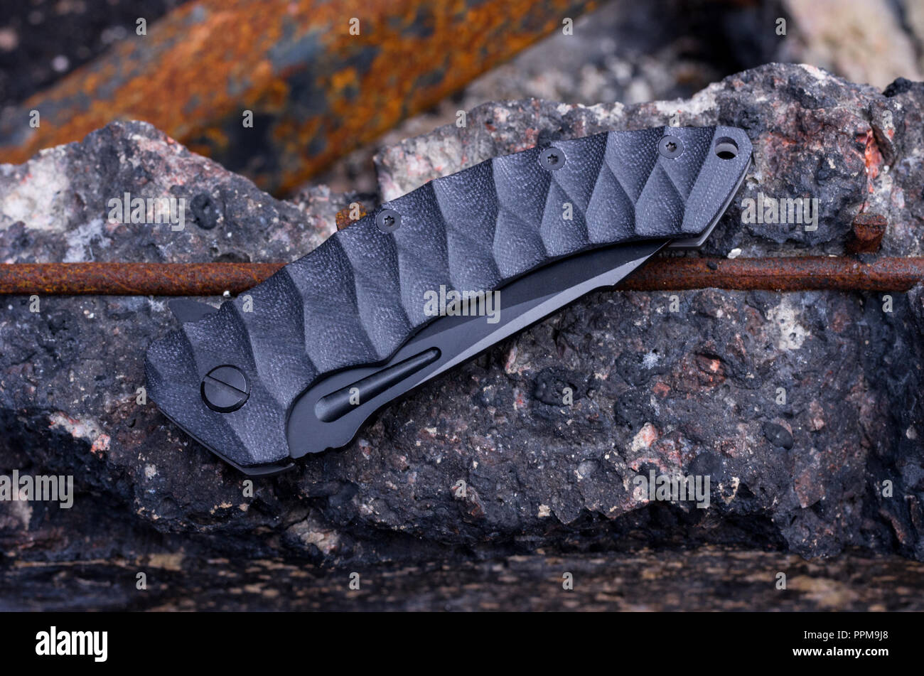 Folded knife. Knife with plastic handle. Black knife and hilt Stock