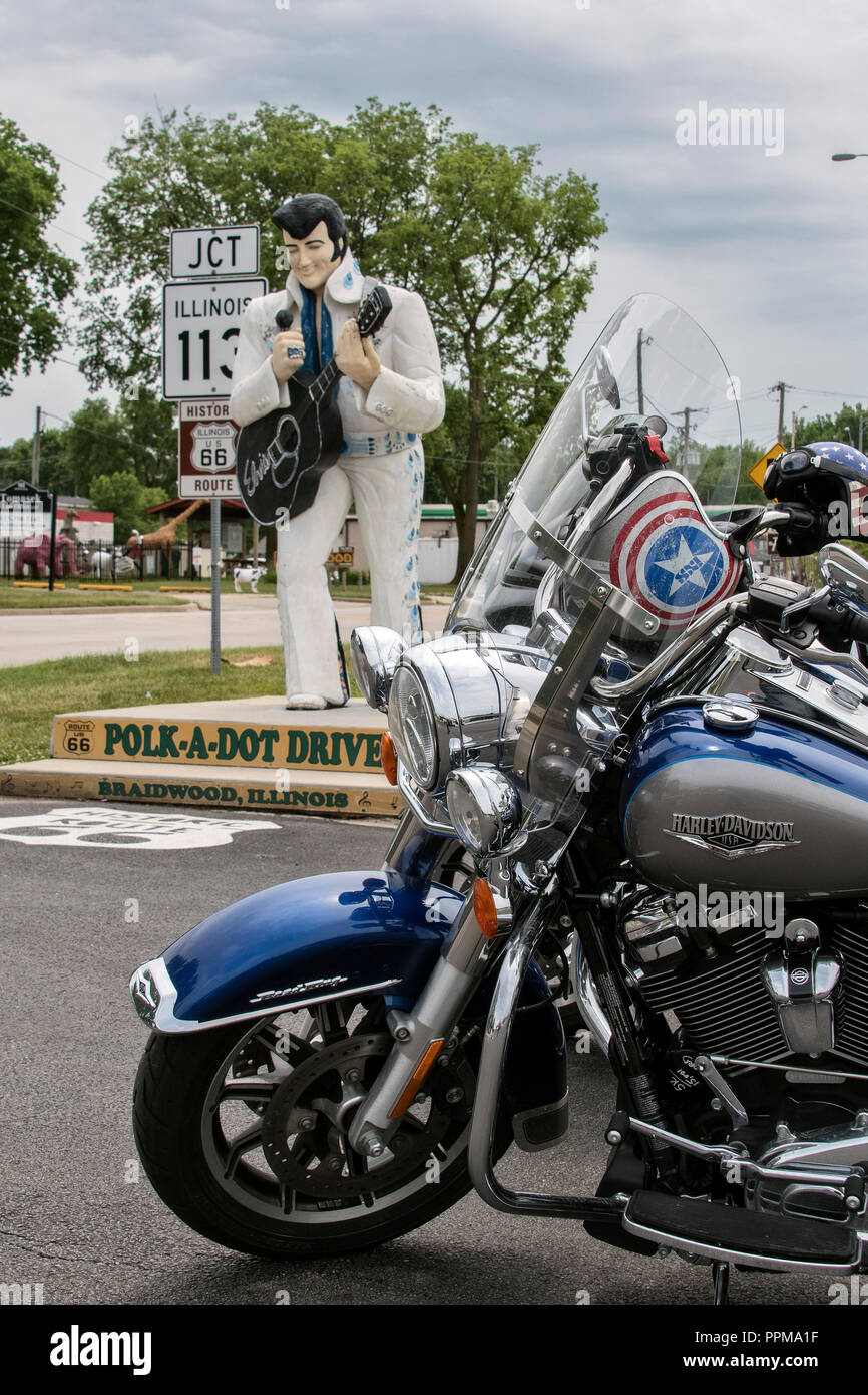 Motorcycle helmet with American flag parked in front of Elvis statue at