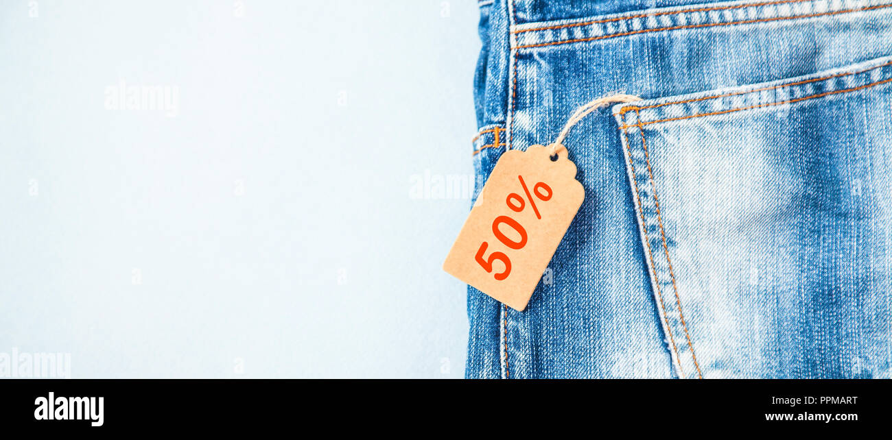 sale, discount, black Friday concept with tag , blue jeans on a light  background. Banner Copyspace Stock Photo - Alamy