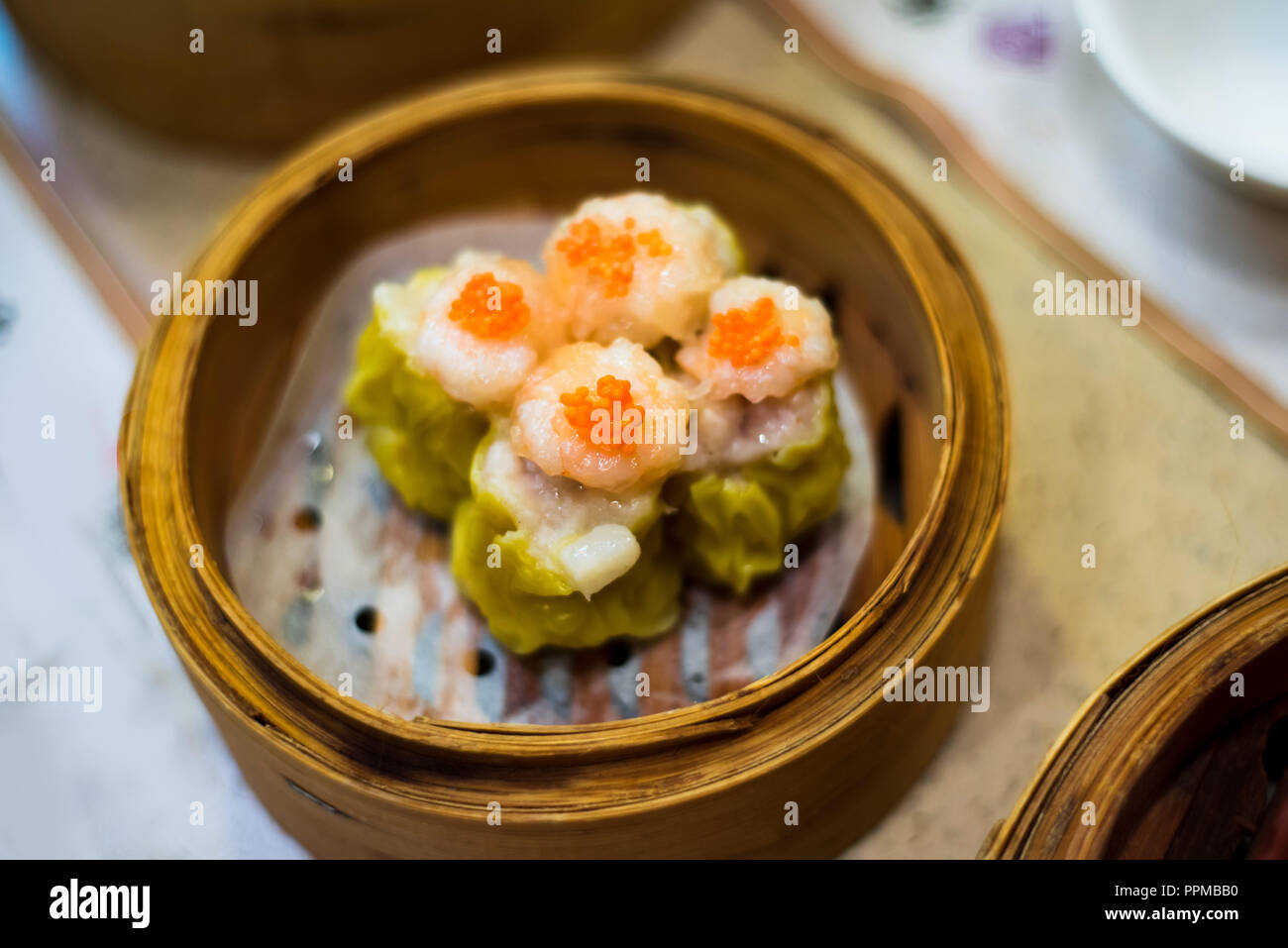 Chinese Cantonese dimsum meal served in traditional bamboo steamer Stock Photo