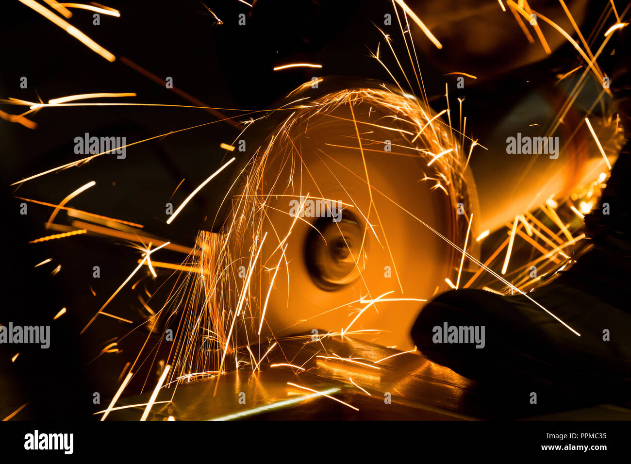 sharpening and cutting of iron by abrasive disk machine Stock Photo - Alamy