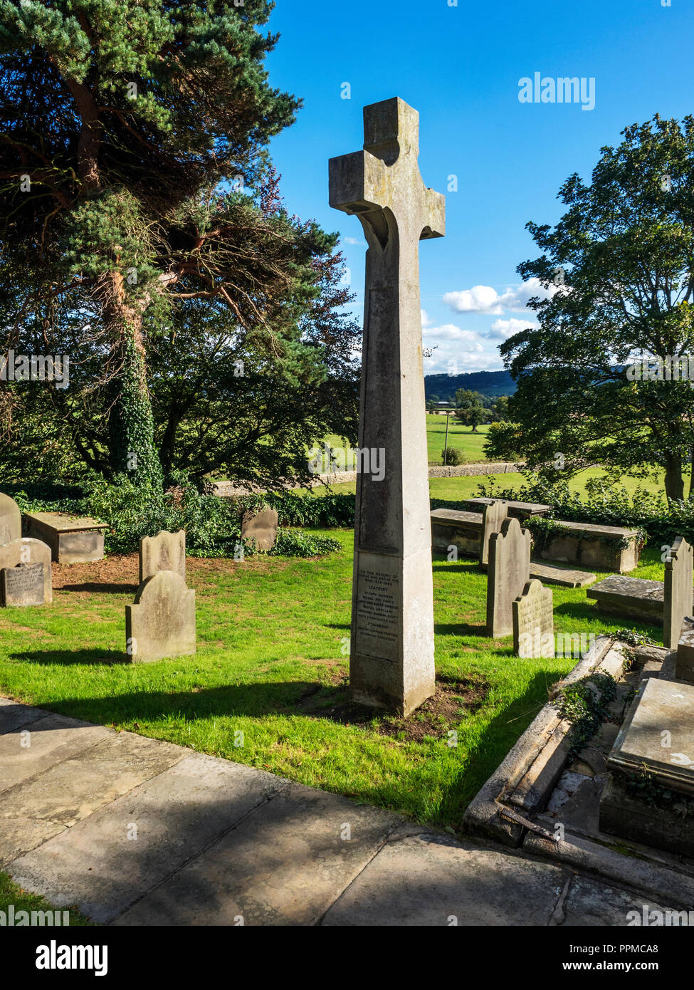 War Memorial in the graveyard at St Oswalds Church at Leathley in the Washburn Valley North Yorkshire England Stock Photo