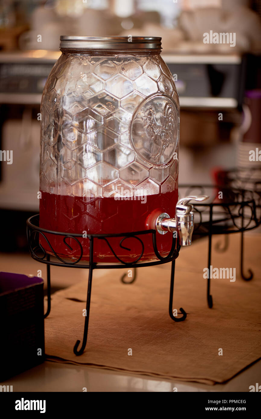 Lemonade in a big jar with a tap.Oranges and lemon. Refreshing summer