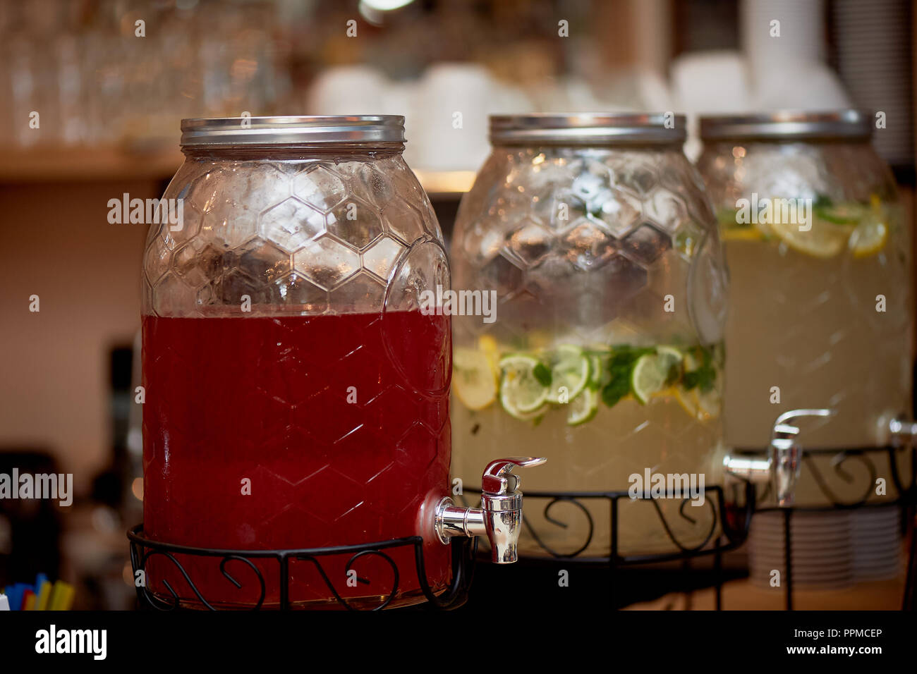 Lemonade in a big jar with a tap.Oranges and lemon. Refreshing summer