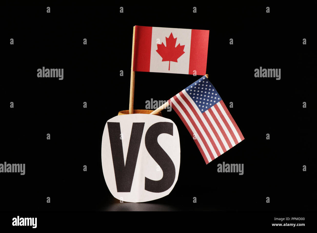 A national flag of Canada and flag of united states. Both lands have different opinions but same language. Black background Stock Photo