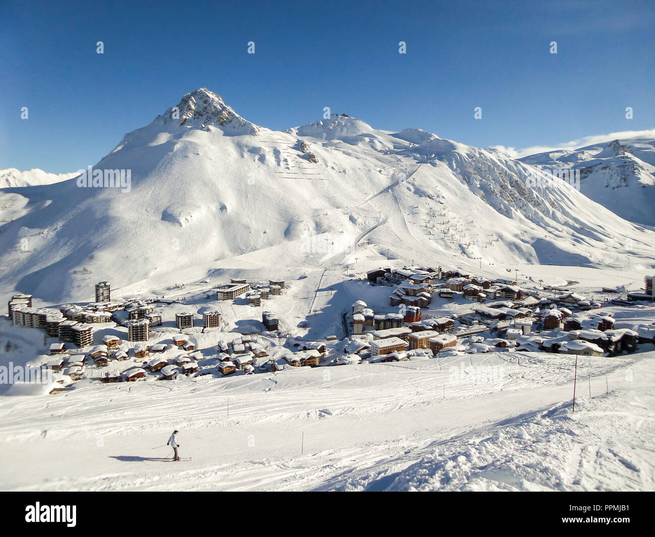 Ski resort of Tignes in winter, ski slope and village of Tignes le lac in the background Stock Photo