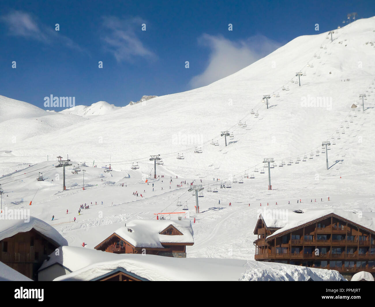 Ski resort of Tignes in winter, ski lifts and village of Tignes le lac in the foreground Stock Photo