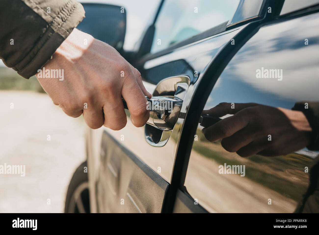 Closeup of a man's hand opens the car door with a key Stock Photo Alamy