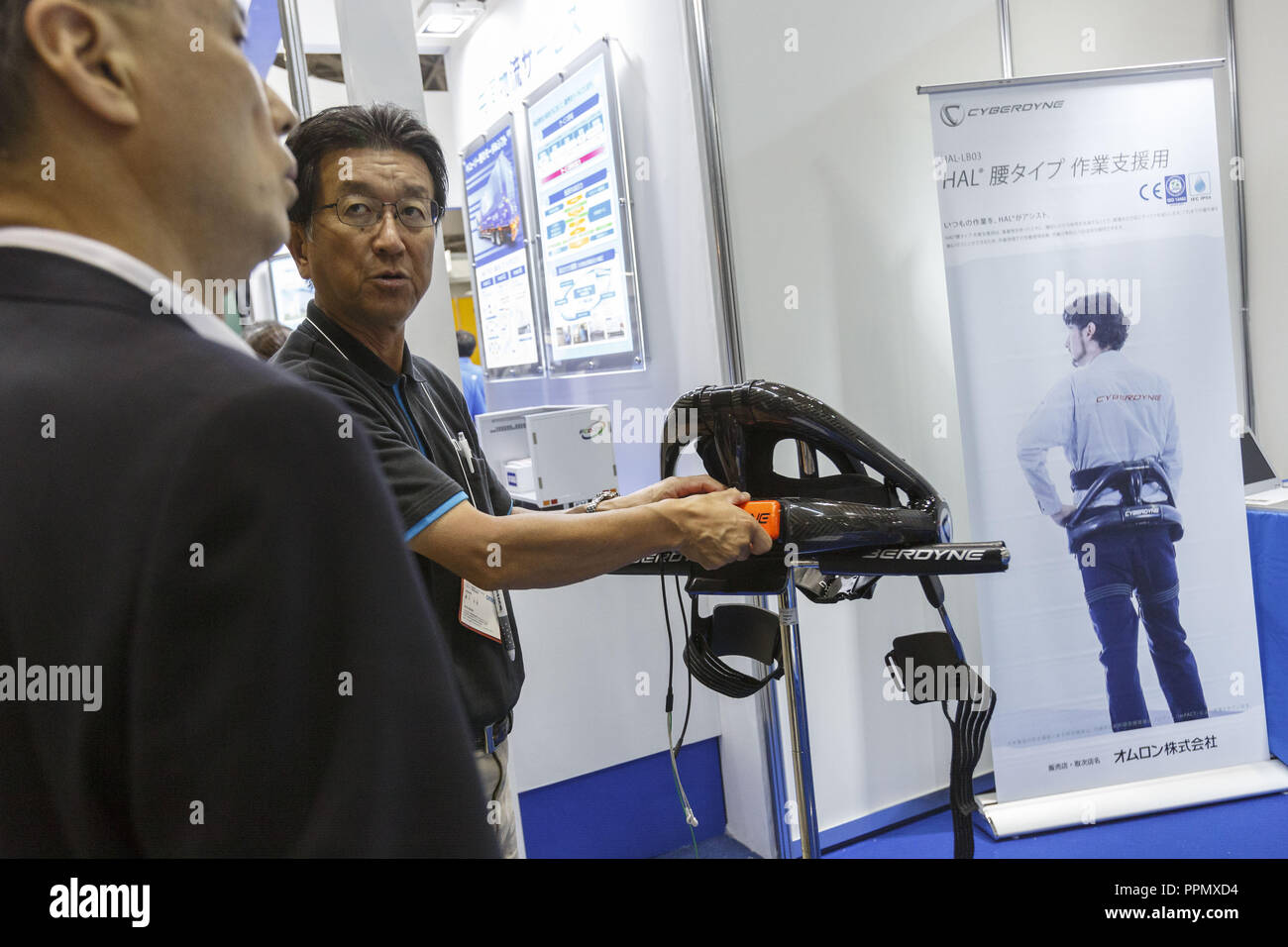 Tokyo, Japan. 26th Sep, 2018. An exhibitor introduces a powered exoskeleton HAL (Hybrid Assistive Limb) during the New Values enhanced by Machine, Material and Processing Technology in Tokyo Big Sight. The exhibition introduces IoT/AI, machine, material and processing technologies form September 26 to 28. Credit: Rodrigo Reyes Marin/ZUMA Wire/Alamy Live News Stock Photo