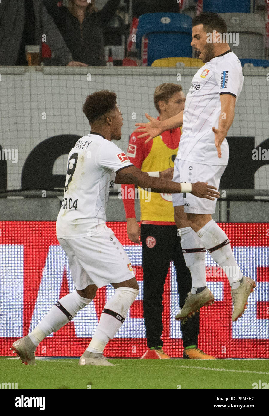 26 September 2018, North Rhine-Westphalia, Düsseldorf: Soccer: Bundesliga, Fortuna Düsseldorf - Bayer Leverkusen, 5th matchday in the Merkur Arena. Leverkusen's Leon Bailey (L) and goal scorer Kevin Volland celebrate the 1-0 victory.      (EMBARGO CONDITIONS - ATTENTION: The DFB prohibits the utilisation and publication of sequential pictures on the internet and other online media during the match (including half-time). ATTENTION: BLOCKING PERIOD! The DFB permits the further utilisation and publication of the pictures for mobile services (especially MMS) and for DVB-H and DMB only after the en Stock Photo