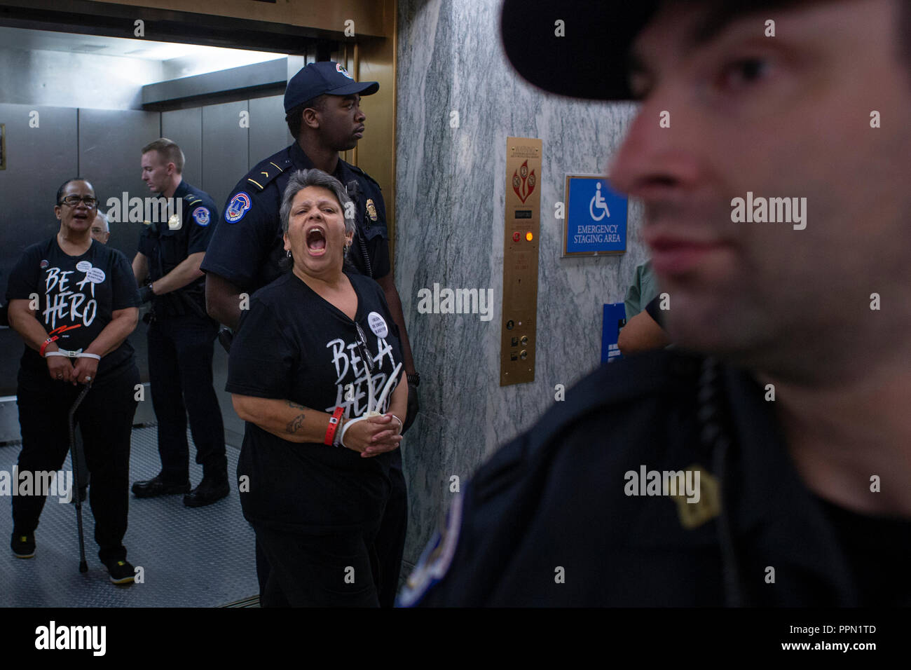 United States Capitol Police officers escort detained demonstrators on Capitol Hill in Washington, DC on September 26, 2018. The demonstrators are protesting against the nomination of Judge Brett Kavanaugh to be a Supreme Court Associate Justice. Credit: Alex Edelman/CNP | usage worldwide Stock Photo