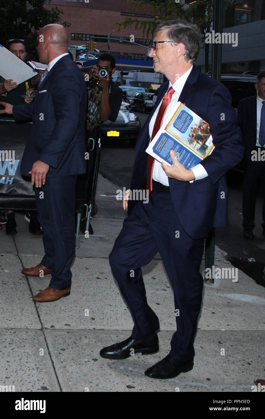 New York, NY, USA. 26th Sep, 2018. Bill Gates at The Daily Show with Trevor Noah holding a copy of The Donald J. Trump Presidential Twitter Library on September 26, 2018 in New York City. Credit: Rw/Media Punch/Alamy Live News Stock Photo