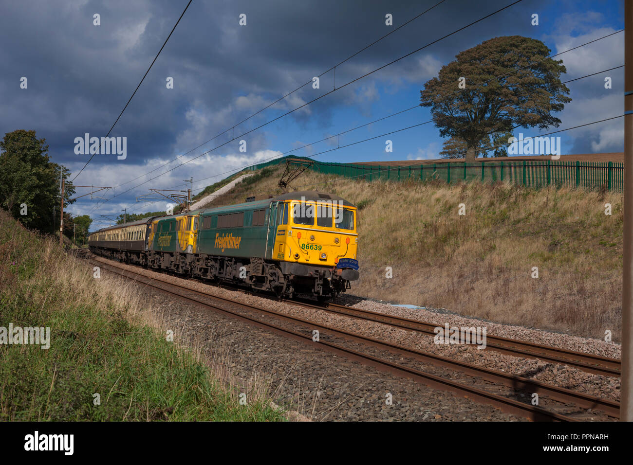 2 Freightliner class 86 locomotives passing Galgate on the west coast main line with the GBRF 2018 charity round Britain railtour Stock Photo