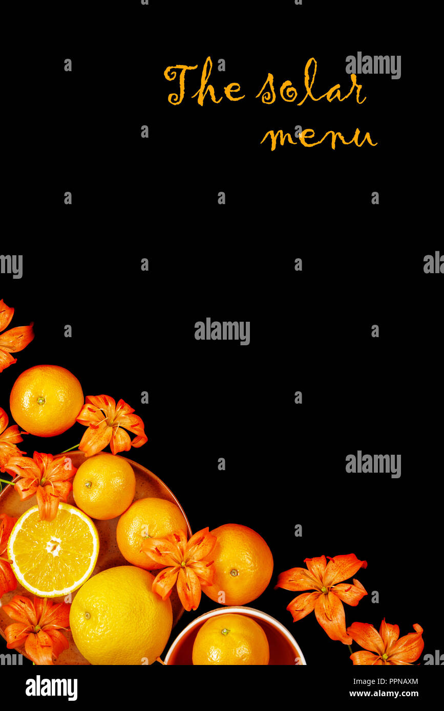 Decorative composition with lily flowers, oranges and mandarines on black background. Flat lay, top view Stock Photo