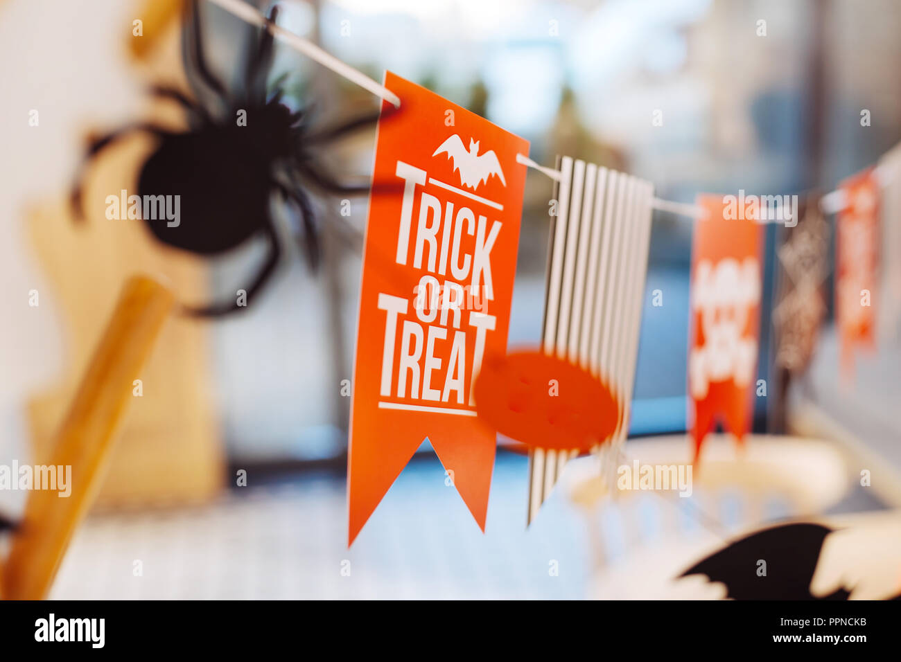 Event managers presenting their Halloween decorations with trick or treat sign Stock Photo