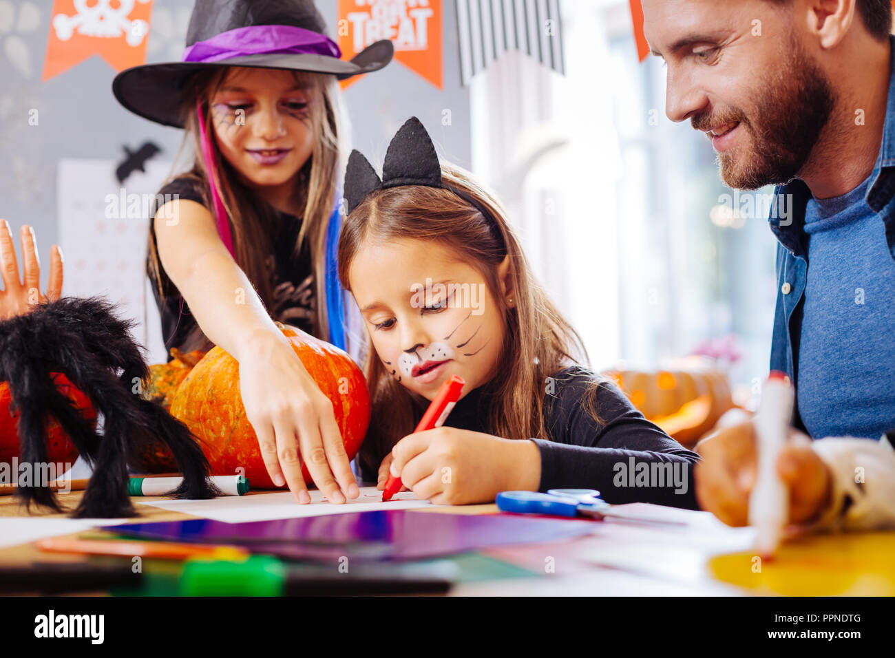 Cute little girl wearing cat Halloween costume having funny painted ...