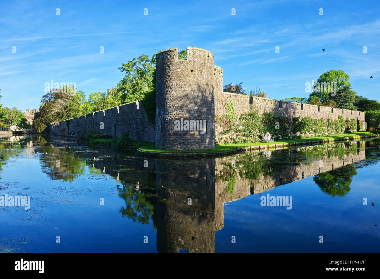 Moat at the Bishop's Palace with clear blue skies in Wells, Somerset,  UK Stock Photo