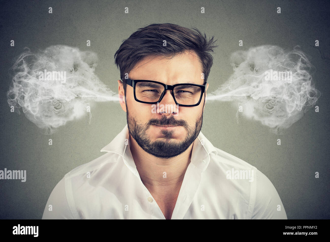 Closeup portrait of angry young man, blowing steam coming out of ears