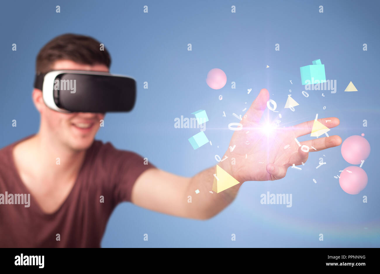 Young impressed man wearing virtual reality goggles with geometric ...