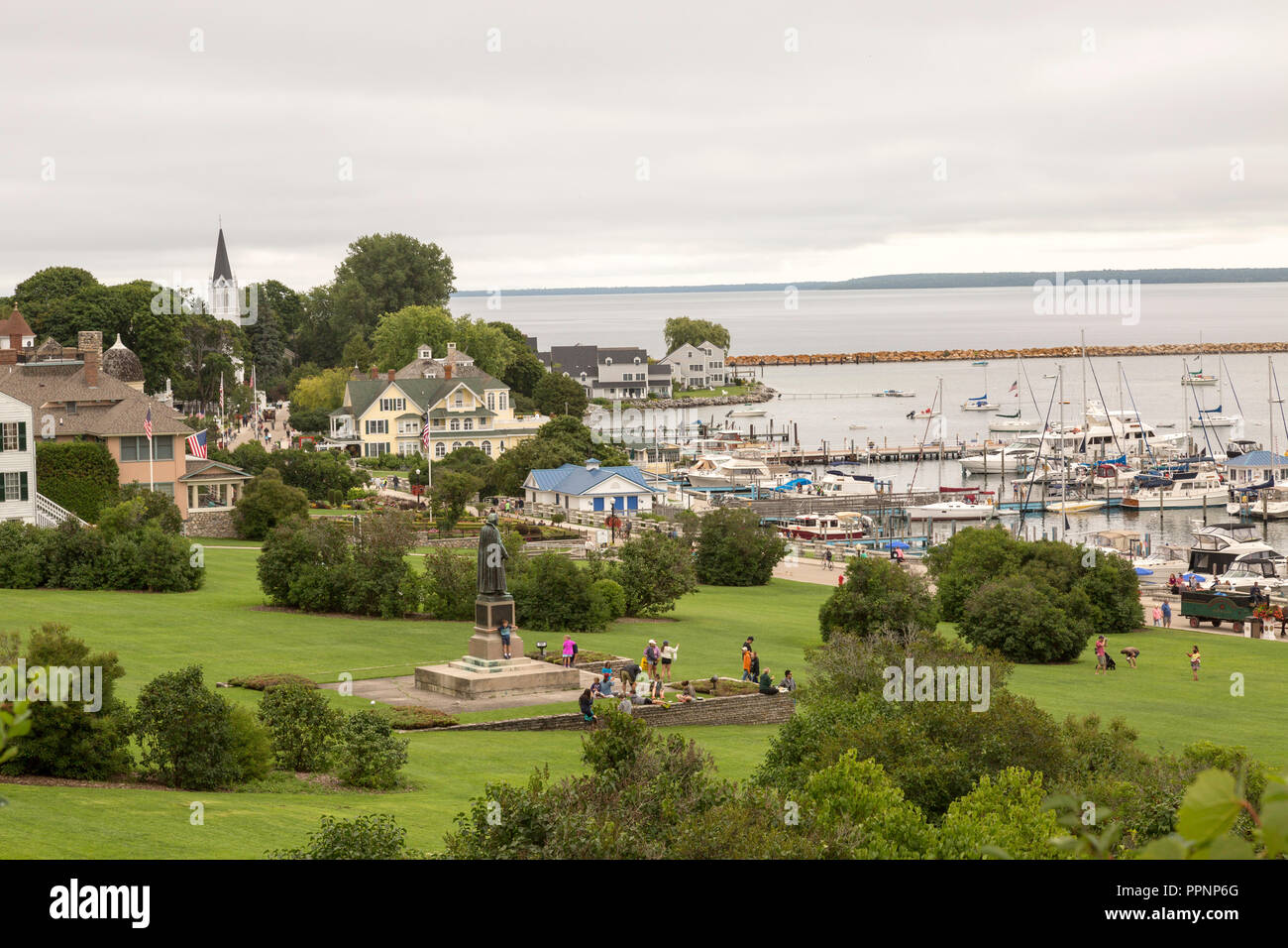 View from above of the town, harbor and Marquette Park with tourists, on Mackinac Island, Michigan. Stock Photo