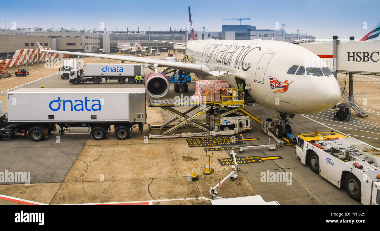 LONDON HEATHROW - JUNE 2018: Wide angle view of air freight being loaded into the cargo hold of a Virgin Atlantic Airbus A330 at  Heathrow airport. Stock Photo