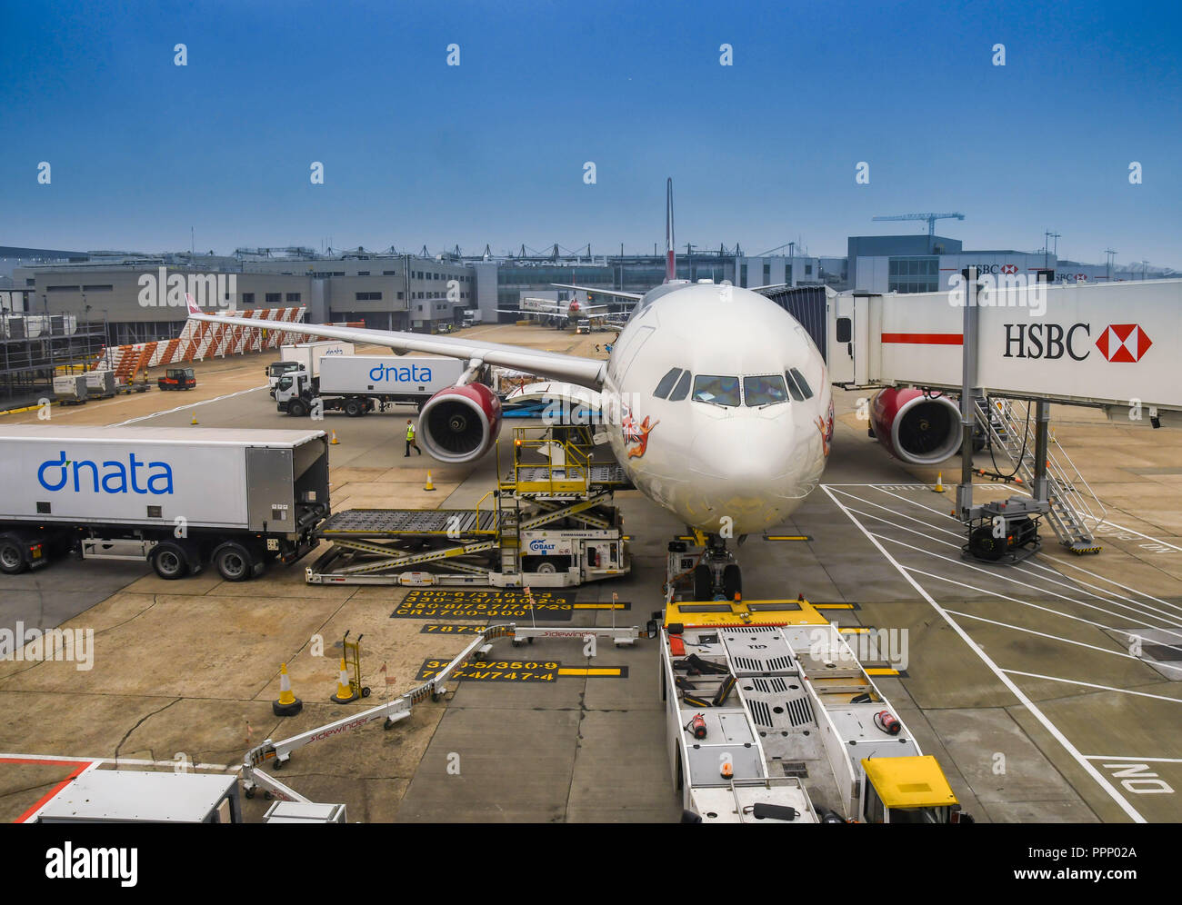 LONDON HEATHROW - JUNE 2018: Wide angle view of air freight being loaded into the cargo hold of a Virgin Atlantic Airbus A330 at  Heathrow airport. Stock Photo