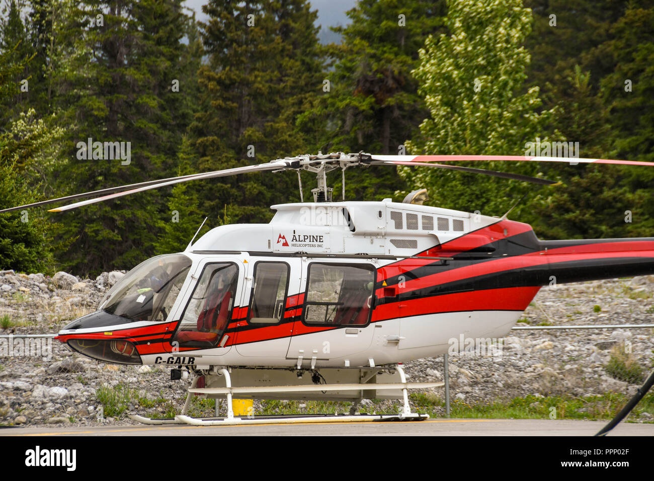 CANMORE, ALBERTA, CANADA - JUNE 2018: Bell 407 helicopter operated by Alpine Helicopters from its base in Canmore. Stock Photo