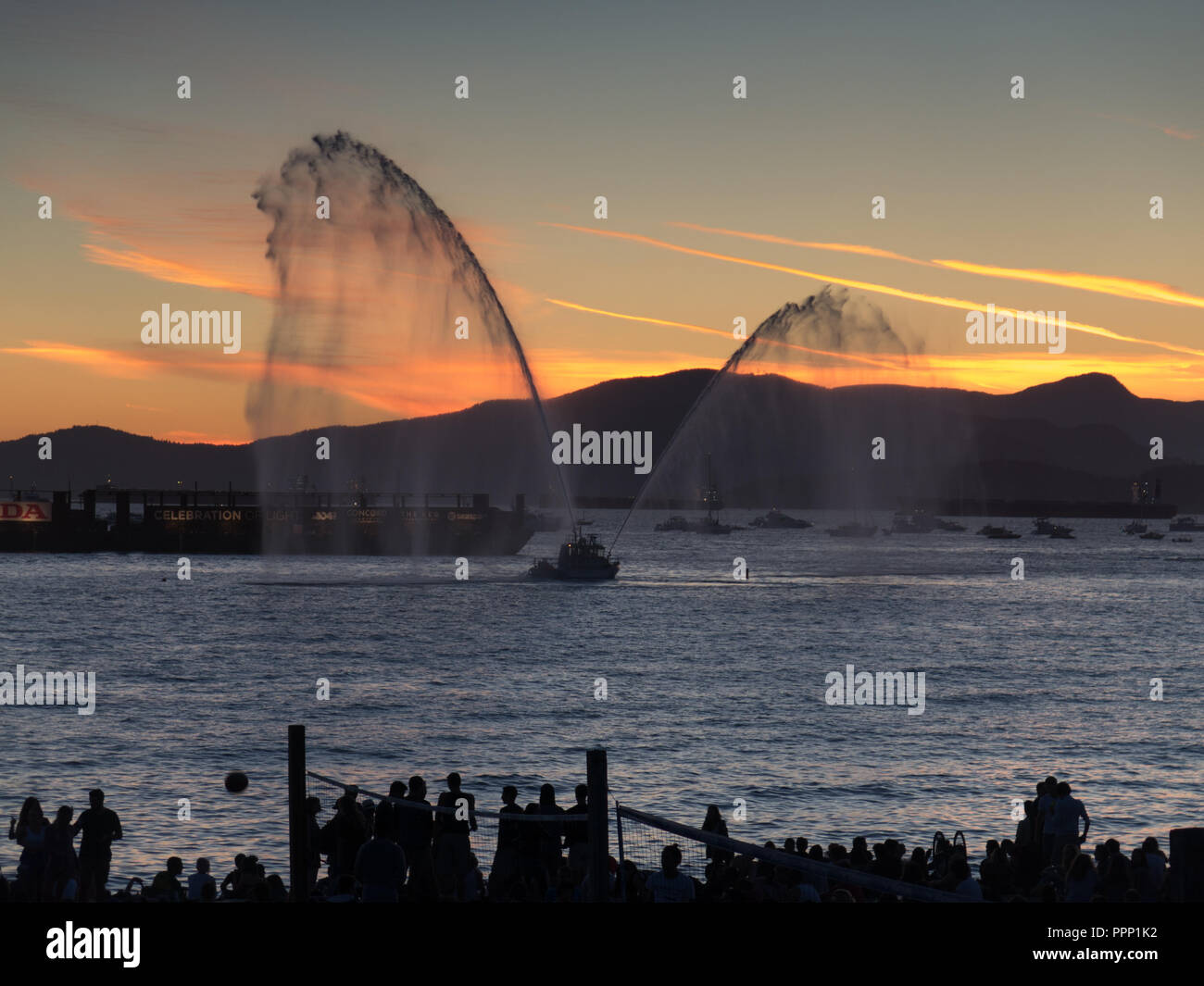 Canadian Fire Boat sunset water spray Stock Photo - Alamy