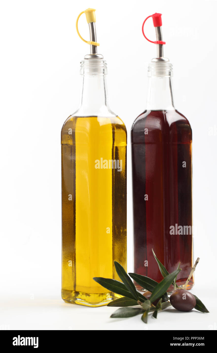 Olive branch with fruit against bottles with olive oil and vinegar Stock Photo Alamy