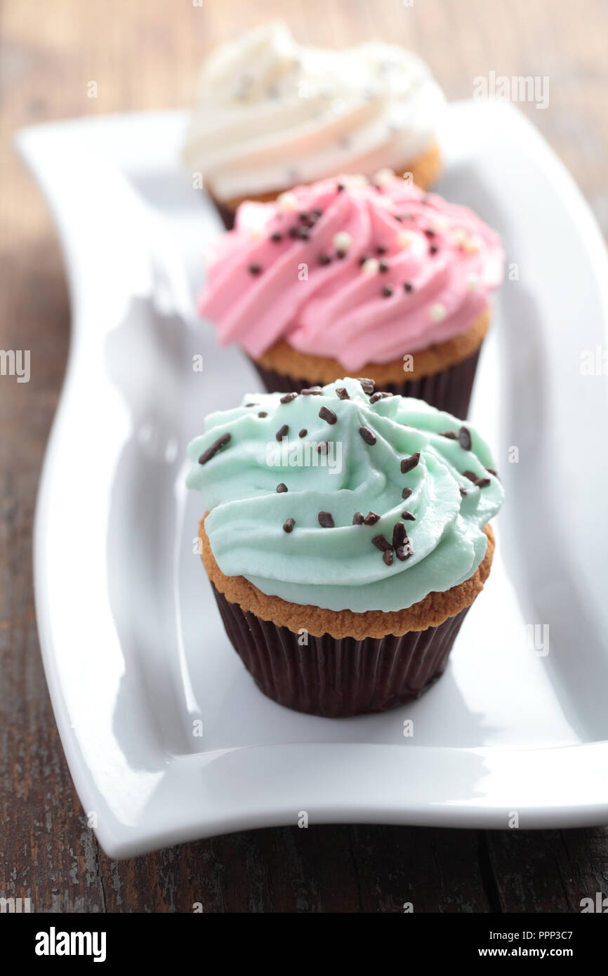 Cupcakes with icing and sprinkles Stock Photo