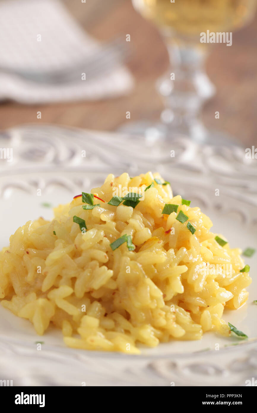 Saffron risotto with parsley on a plate closeup Stock Photo