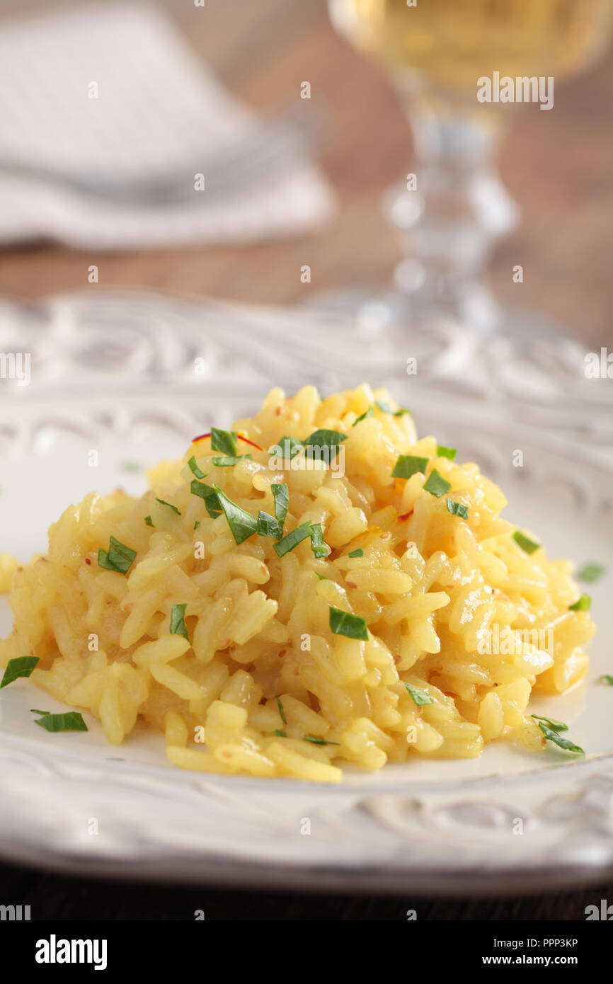 Saffron risotto with parsley on a plate closeup Stock Photo